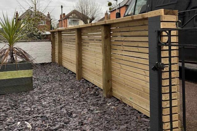 Horizontal slatted timber fencing along a front boundary in West Bridgford