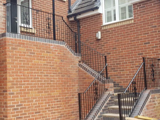 Black metal handrail running up a front garden stairway in Nottingham