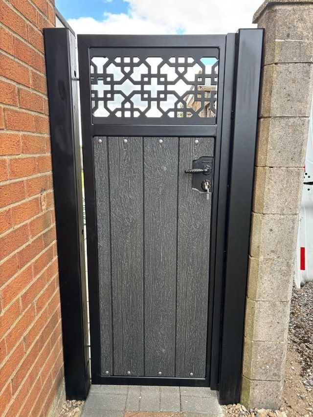Anthracite grey composite pedestrian gate with a cathedral design screen top in a black frame