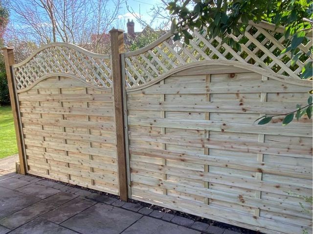 Close view of an arched hit and miss fence panel with the trellis built into the top of the panel rather than added separately