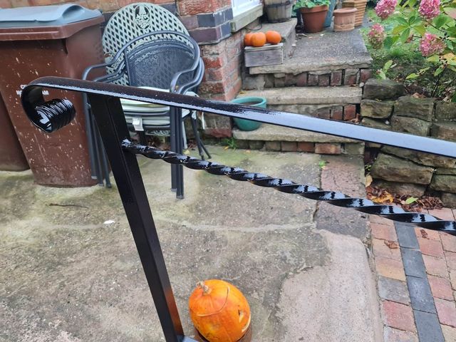 Close up of a twisted metal handrail in a front garden