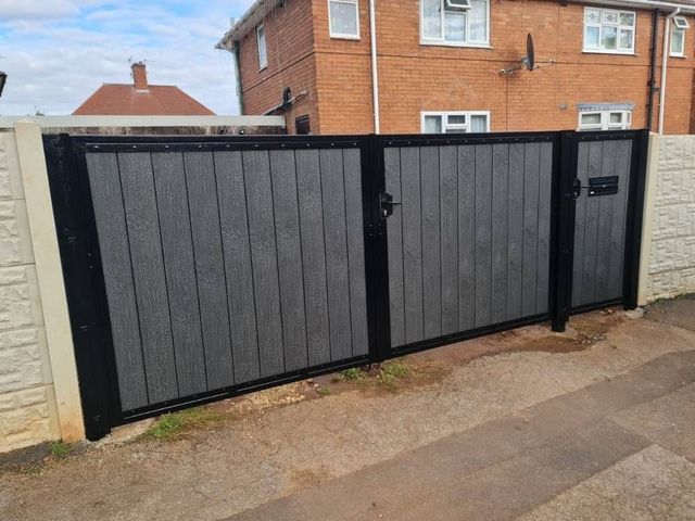Composite driveway gates and matching pedestrian gate with an integrated postbox, seen from the street