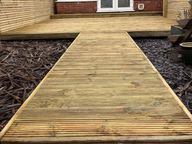 The same West Bridgford deck seen from the garden end, looking back along the decked walkway towards the house