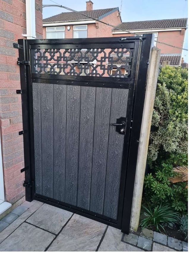 Wide anthracite grey composite pedestrian gate with cathedral screen top standing open