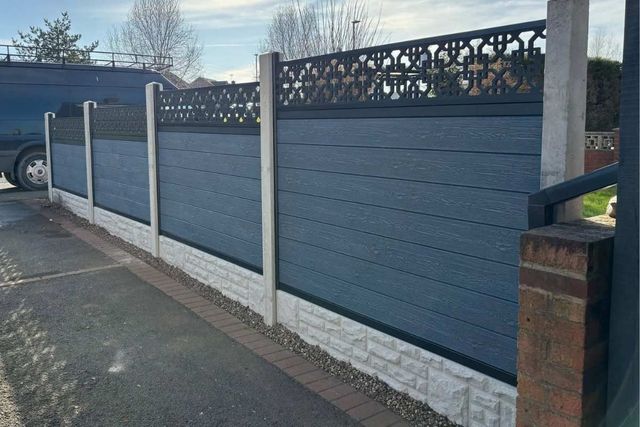 Silver grey composite fence panels fitted into concrete posts with gravel boards in Mansfield