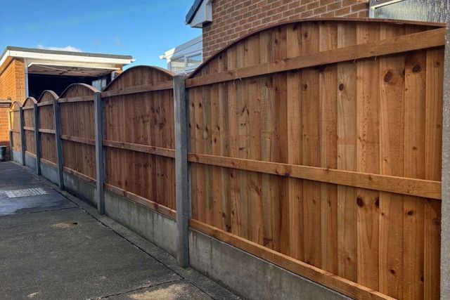 Arched top timber fence panels on concrete posts and gravel boards in Mansfield