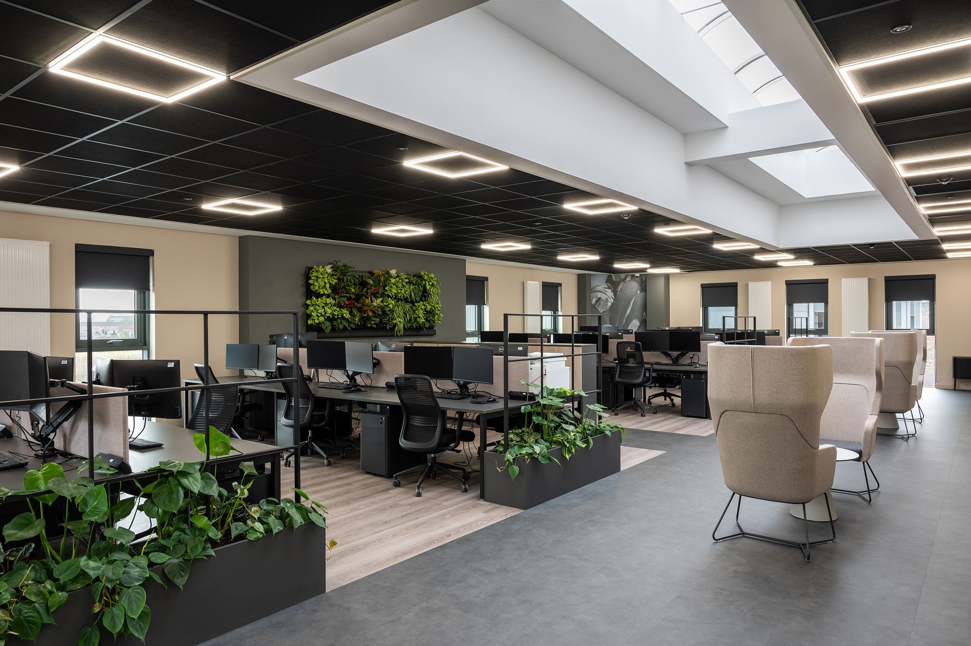 A large open office with lots of desks and chairs.