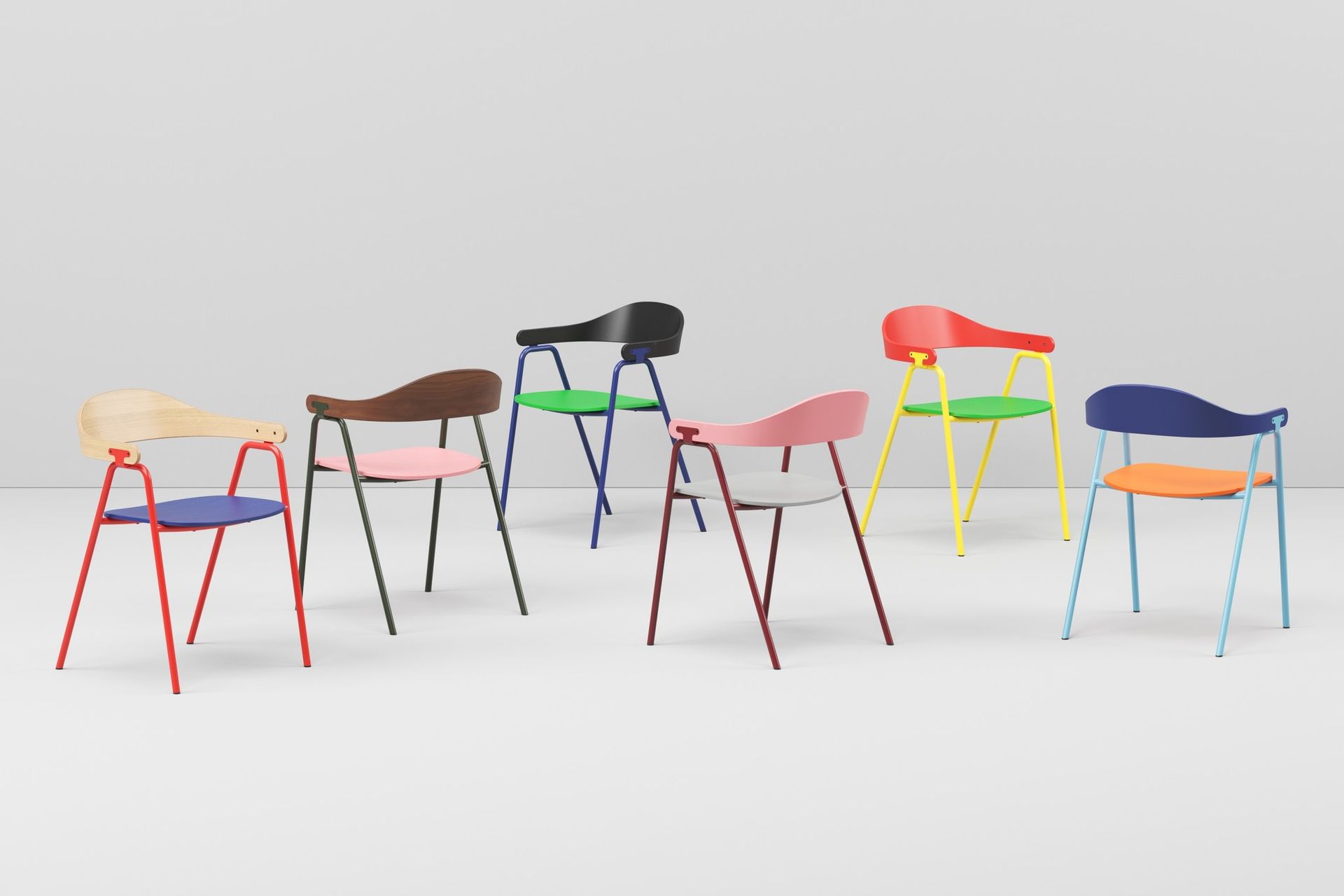 Six colorful modern chairs against a white background.