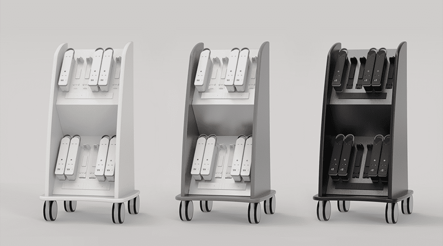 Three mobile shelving units, white, gray, and black, each holding objects, possibly tools.