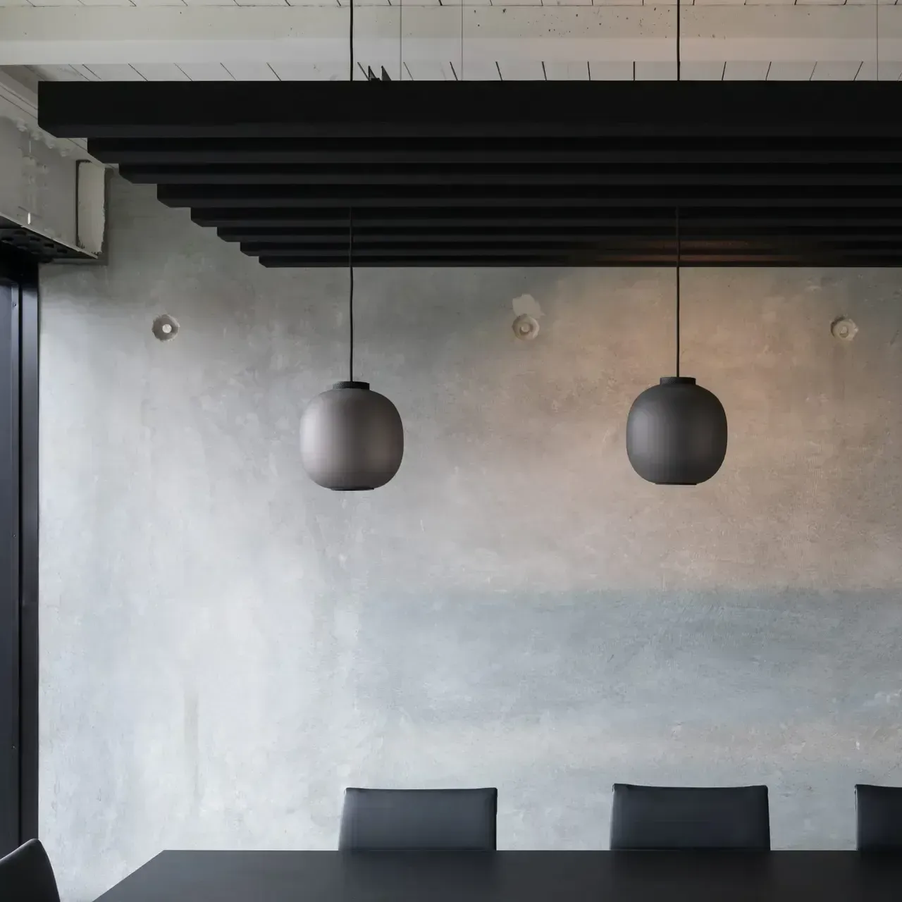 Office furniture Scotland
A modern grey concrete space with black table and chairs and hanging grey balls which serve as an acoustic baffle system. This absorps sound especially well in open-plan spaces. Designers can mix and match colours and styles with the Frontier range.