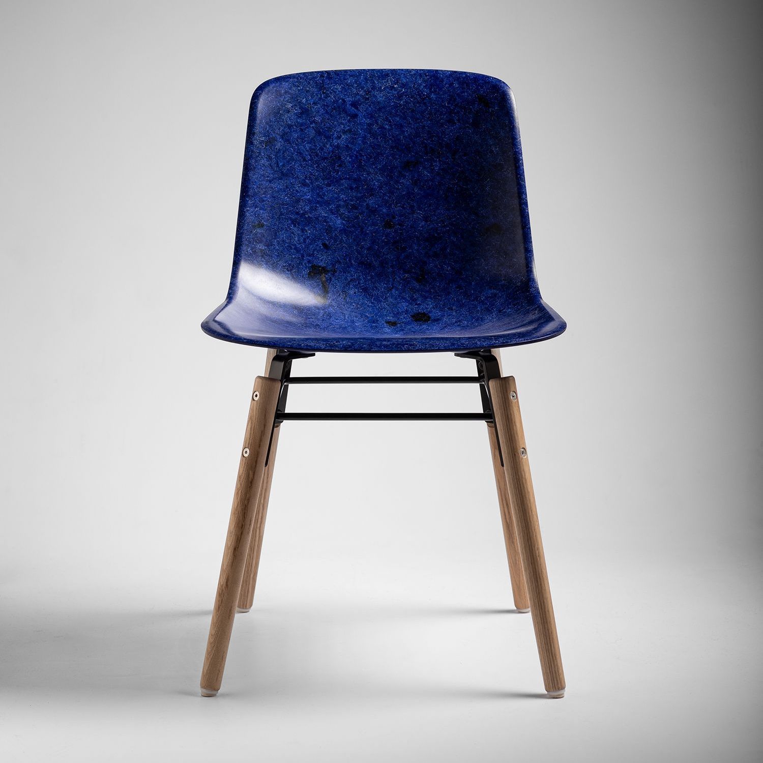 Cobalt Welsh Mountain Solidwool chair shell with oiled ash legs facing front.