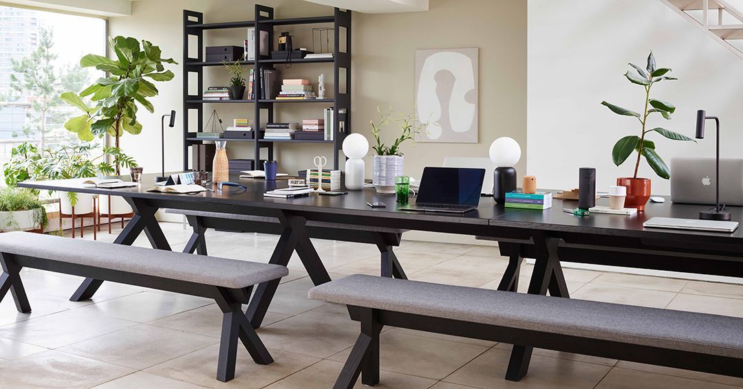 Black-stained VWork table and benches in a modern office space