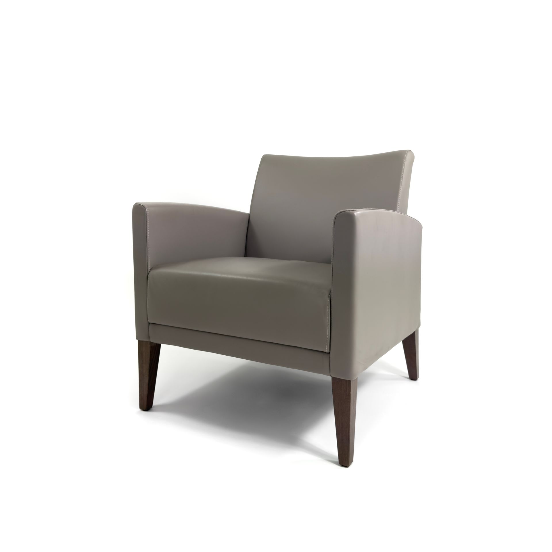 Gray leather armchair with dark wooden legs, angled against a white backdrop.