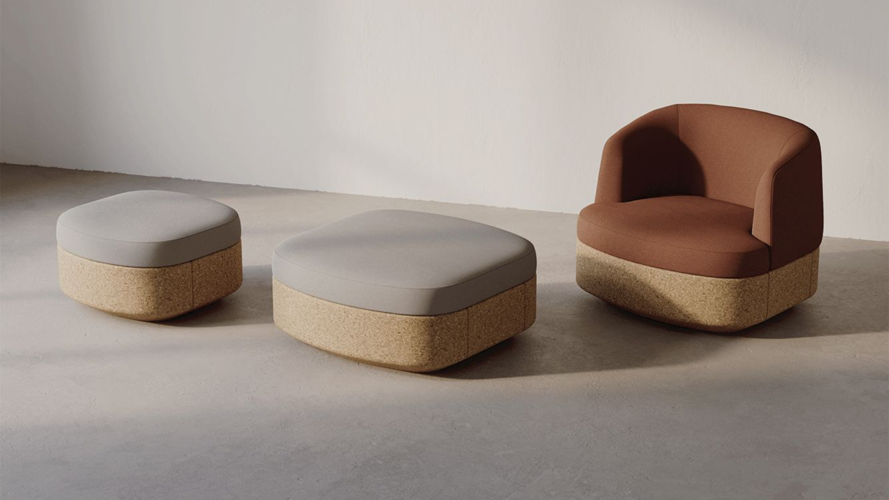 A modern furniture set: armchair and two ottomans, all with brown cork bases and gray/brown upholstery.