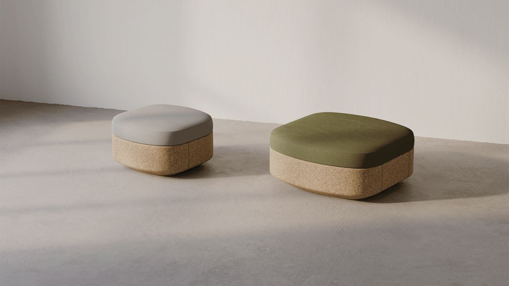 Two hexagonal ottomans, one gray, one green, with cork bases, on a neutral floor.