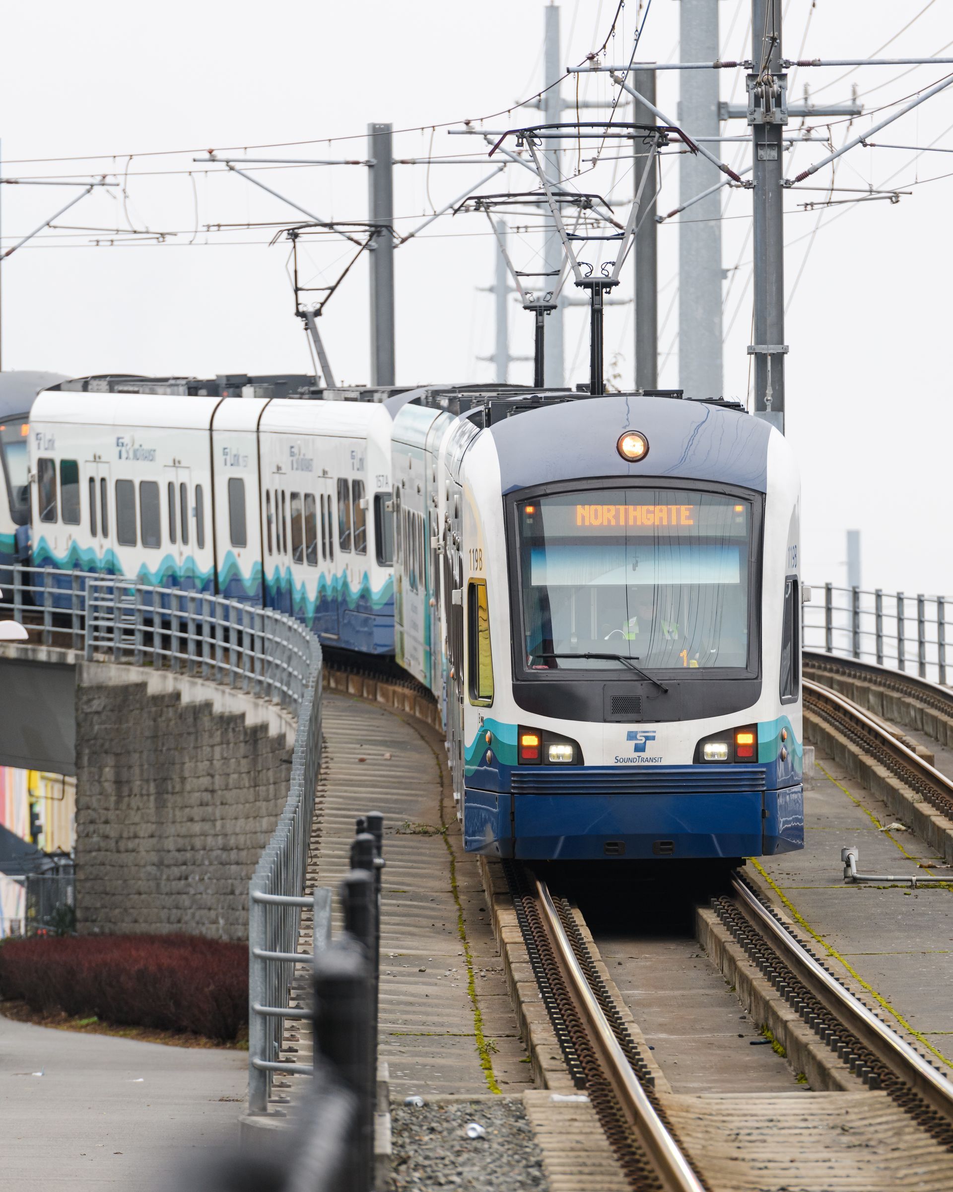A blue and white train with the number 7 on the front