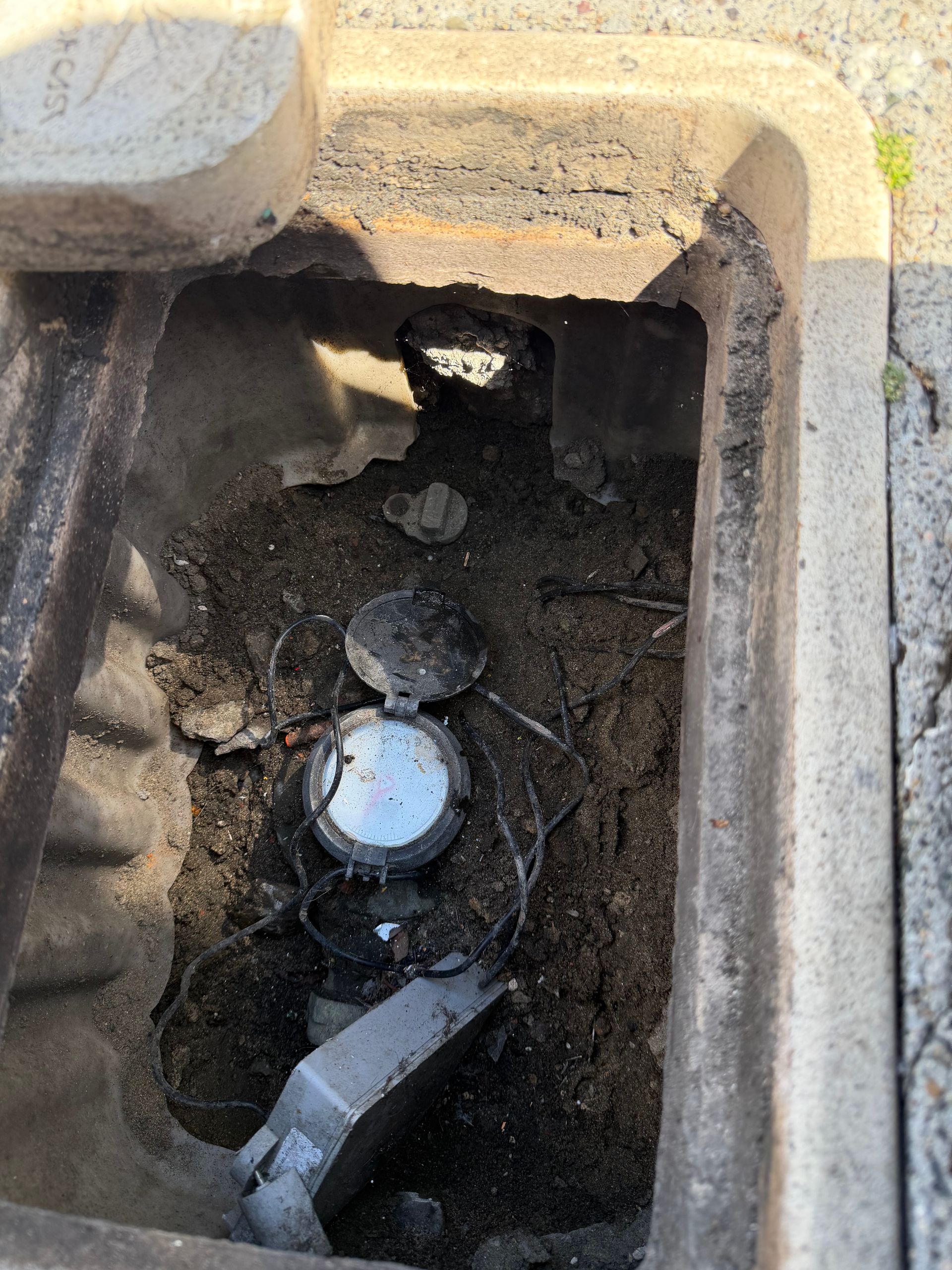 City water meter and shut off valve below sidewalk level