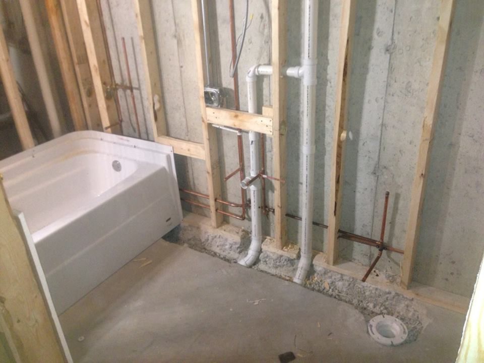 A Bathroom Under Construction With a Bathtub and Pipes — McGill Plumbing & Gas In Beaconsfield, QLD
