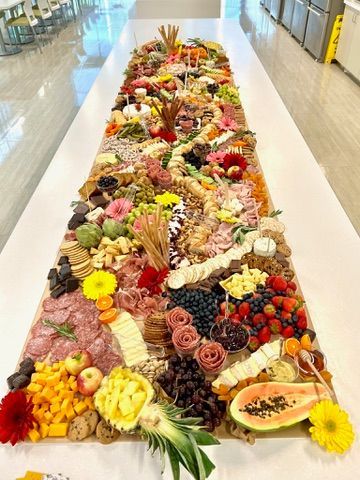 A long table topped with lots of fruits and vegetables.