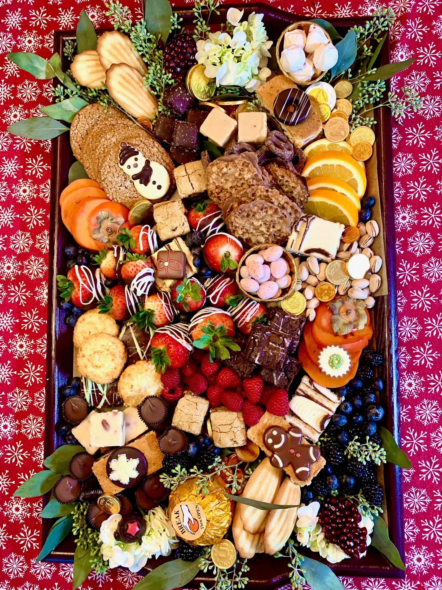 A large tray filled with lots of different types of food on a table.