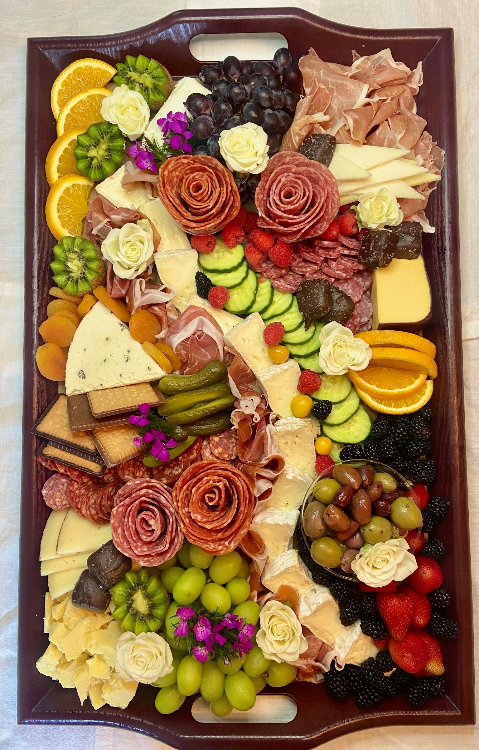 A large tray filled with lots of different types of food.