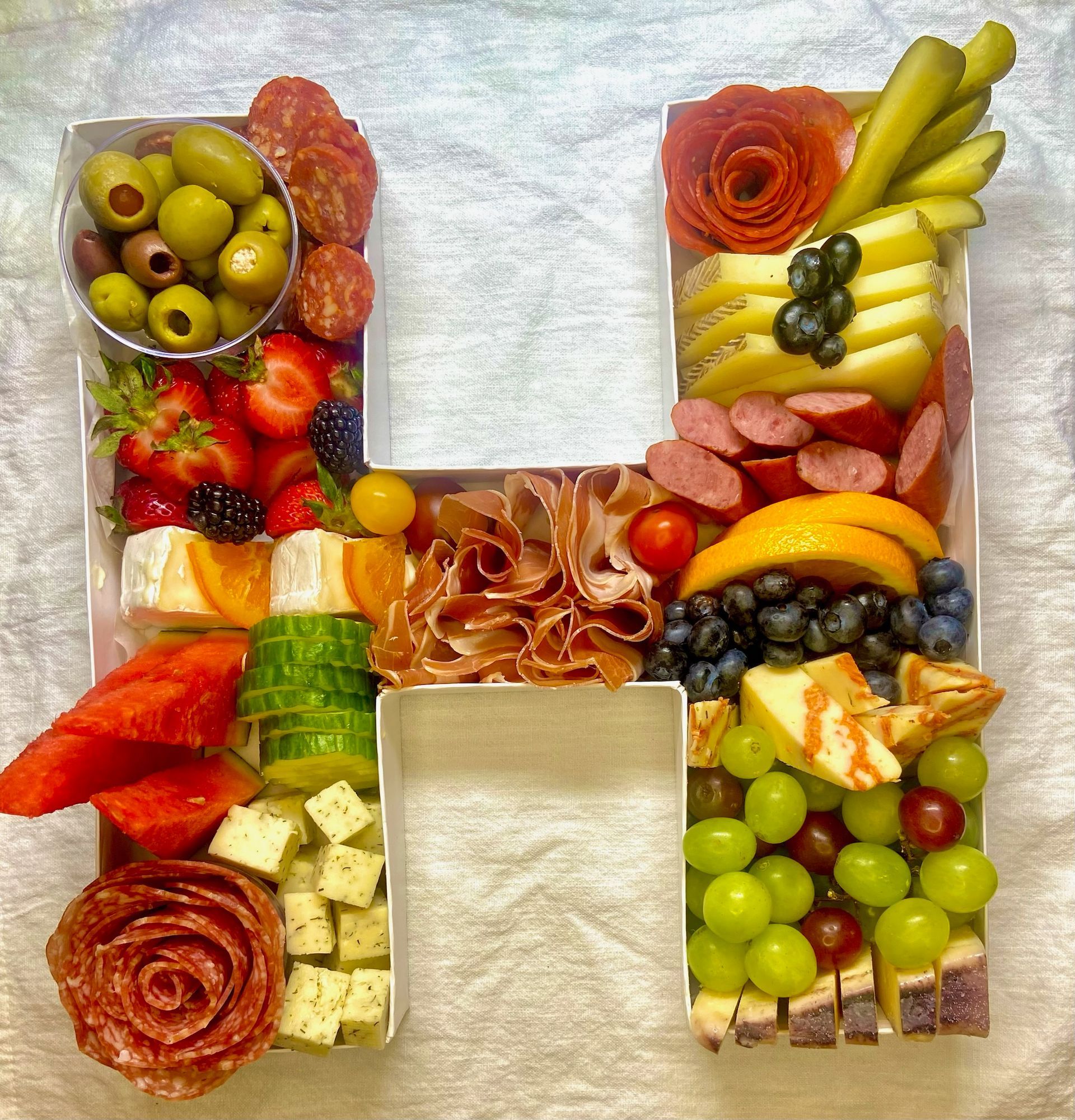 A tray of food in the shape of the letter h.