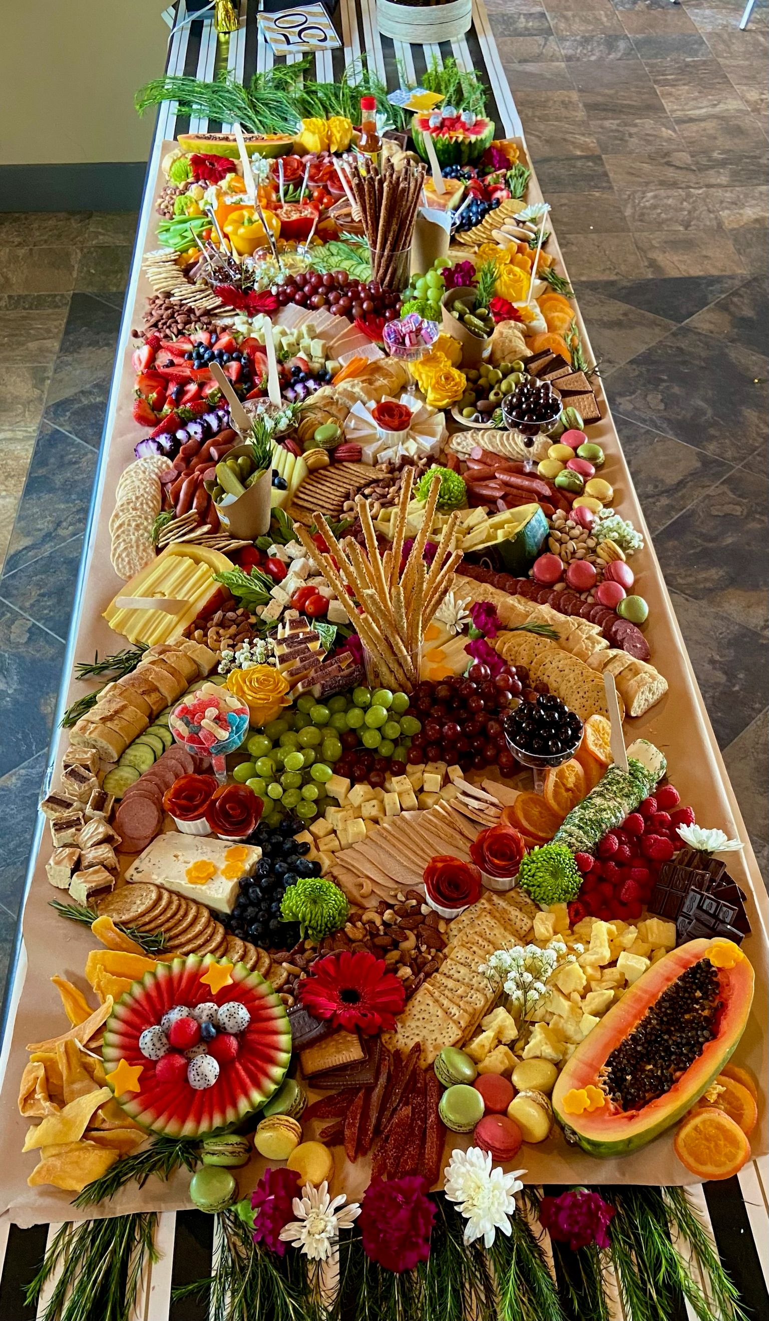 A long table topped with lots of fruits and vegetables.
