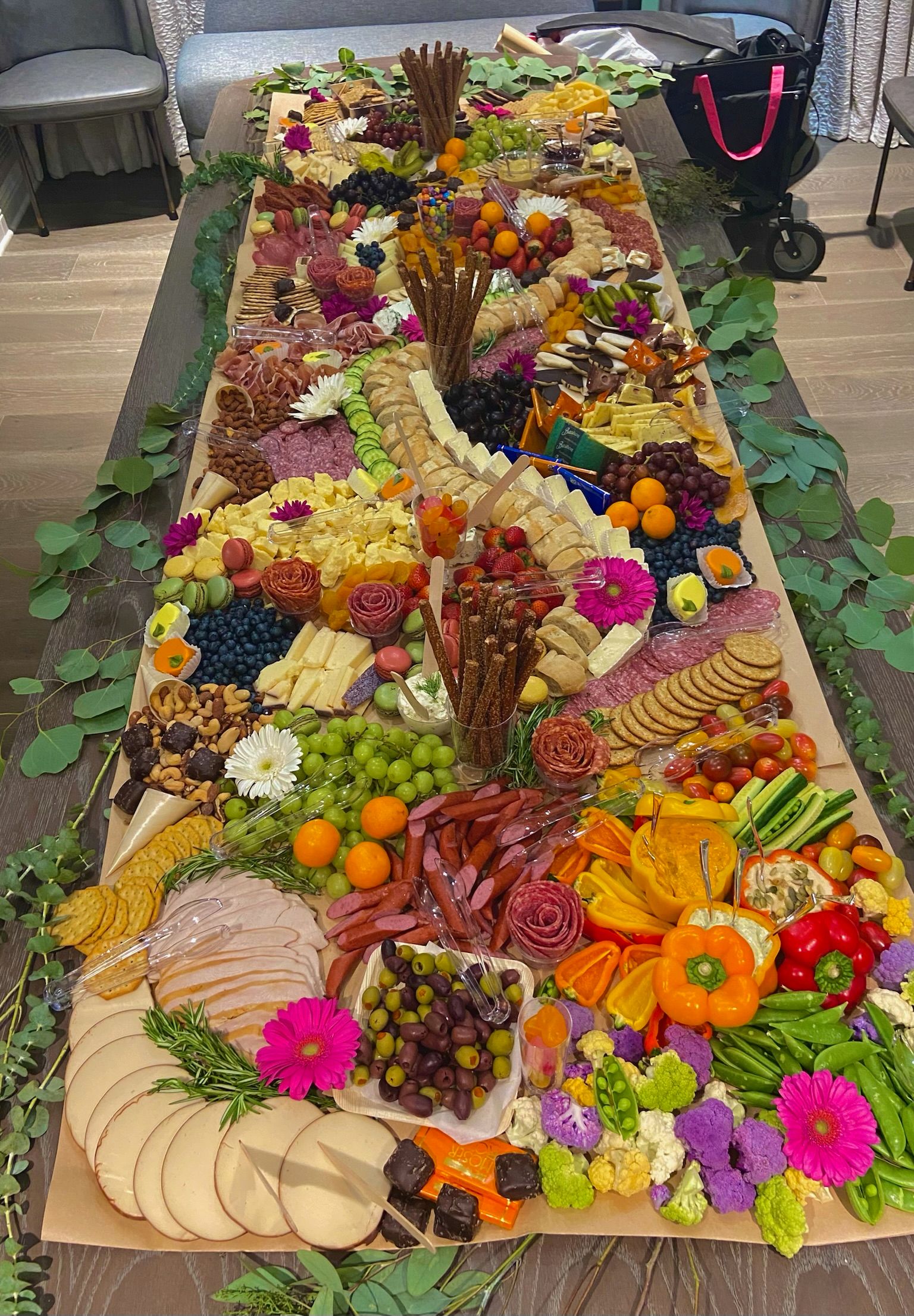 A long table topped with lots of fruits and vegetables.