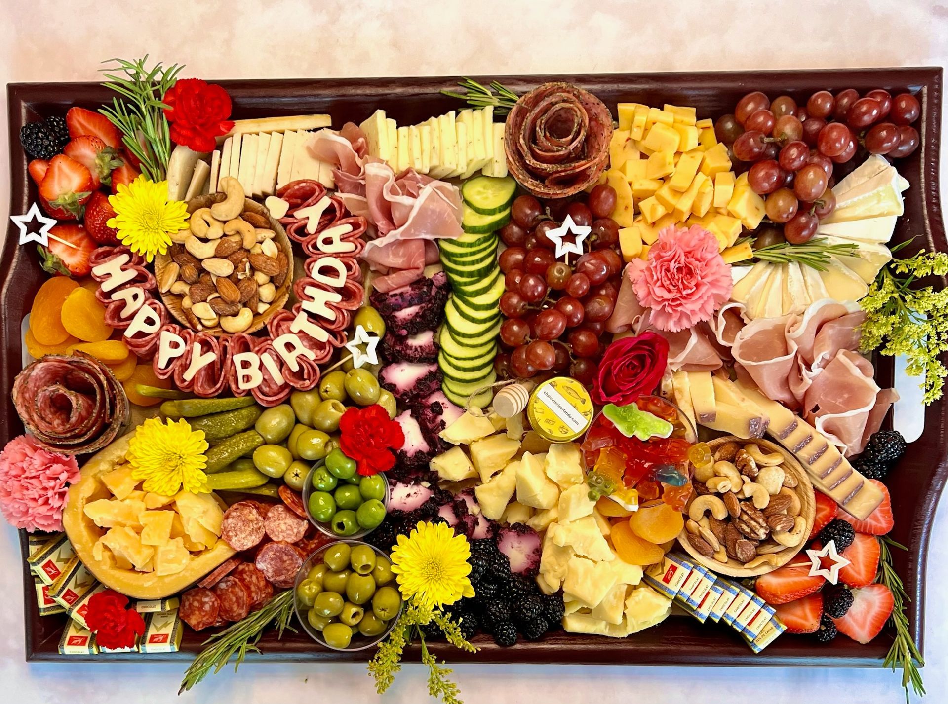 A large platter of food with the words `` happy birthday '' written on it.