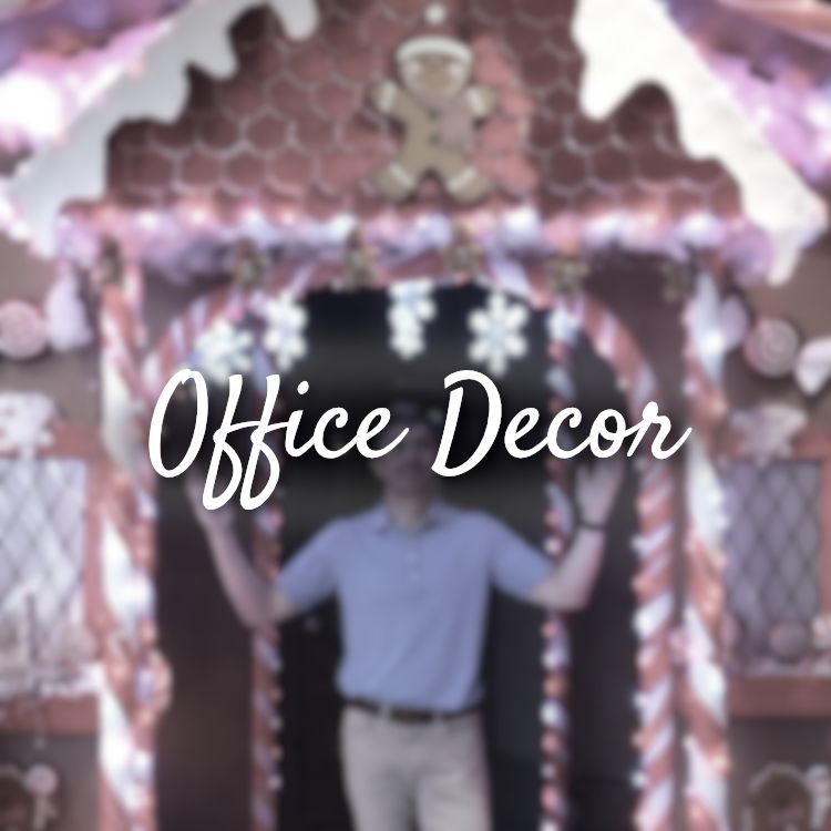 A man standing in front of a gingerbread house with the words office decor above him