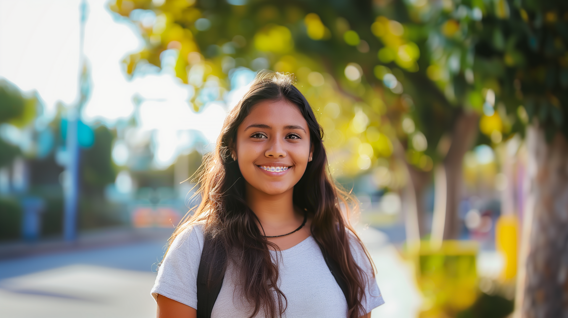 Teenage girl smiling outdoors with braces from Jernigan Orthodontics