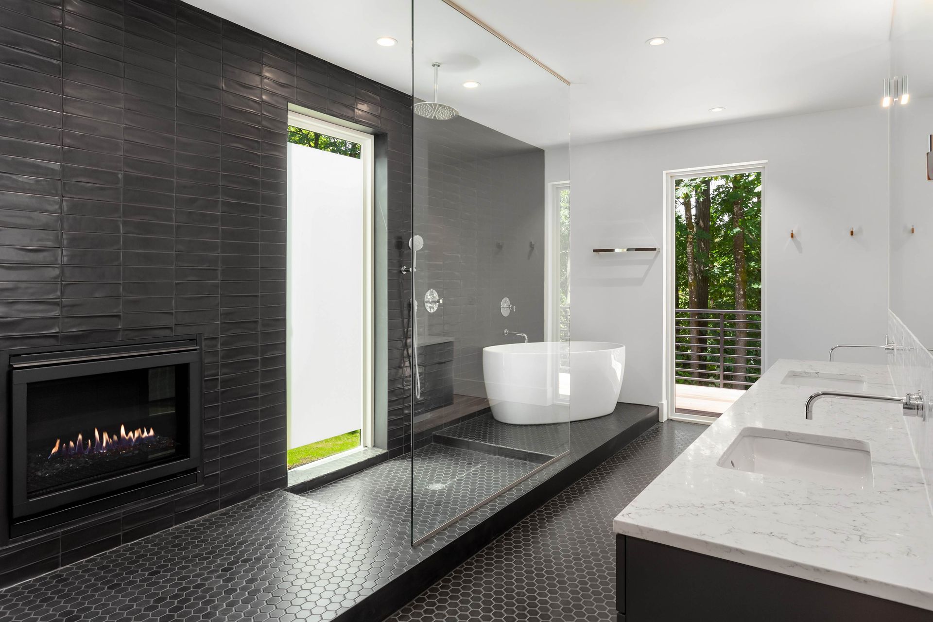 a bathroom with a tub , sink , fireplace and walk in shower