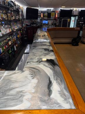 Spilled powder covers the floor of a store aisle, with shelves on the left and a wooden counter on the right