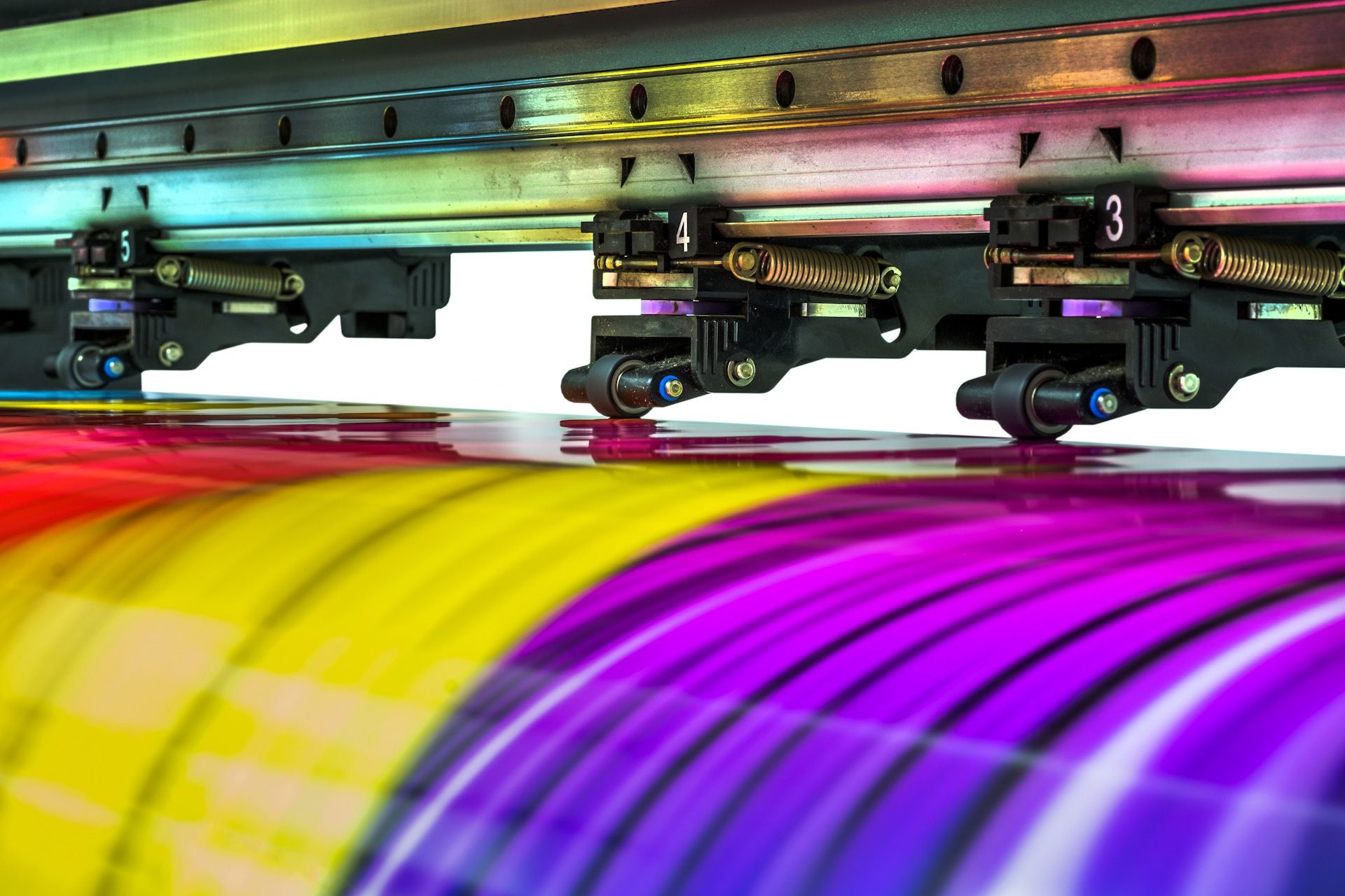 A close up of a printer printing a colorful sheet of paper.
