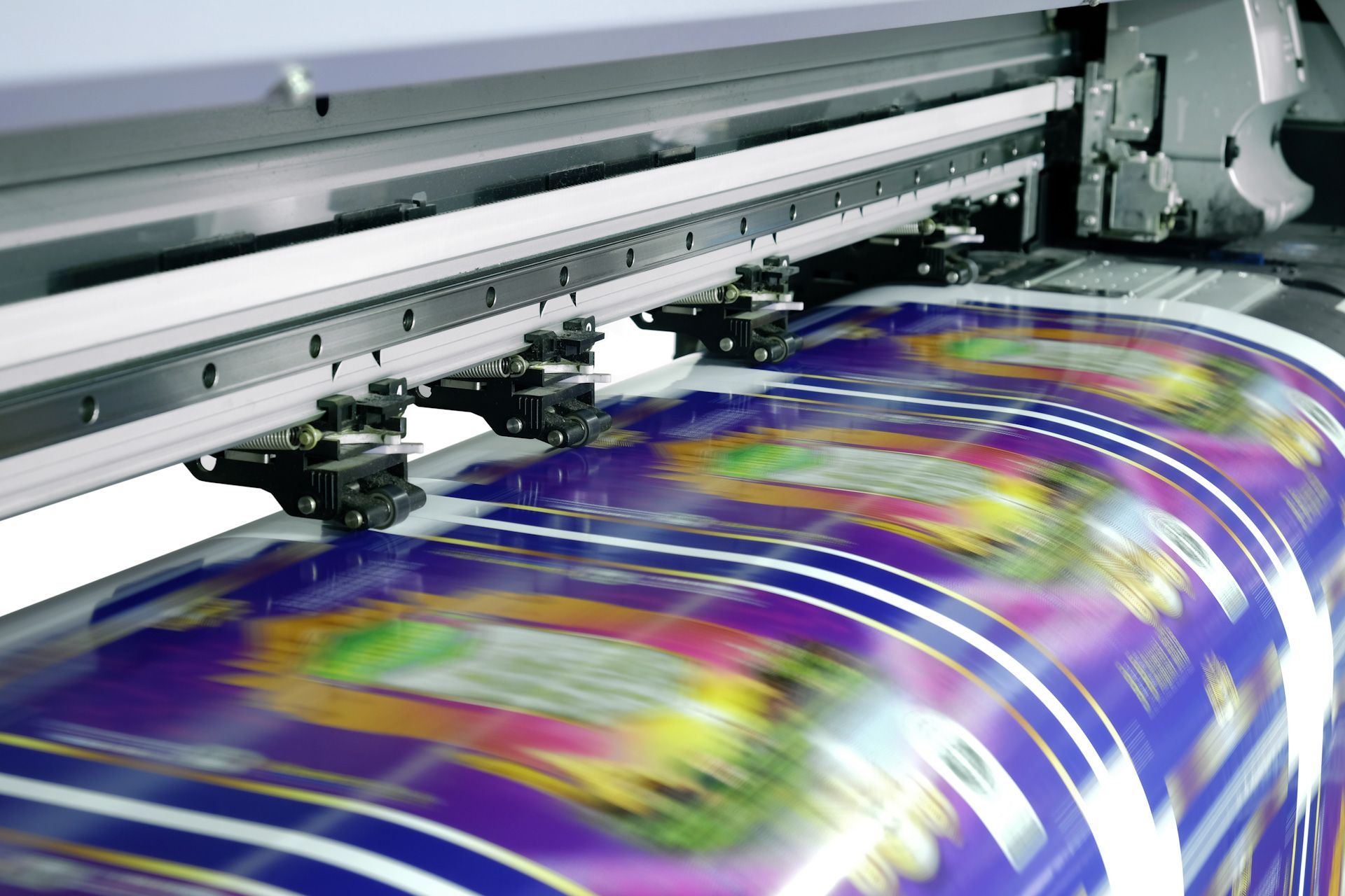 A large printing machine is printing a large sheet of paper