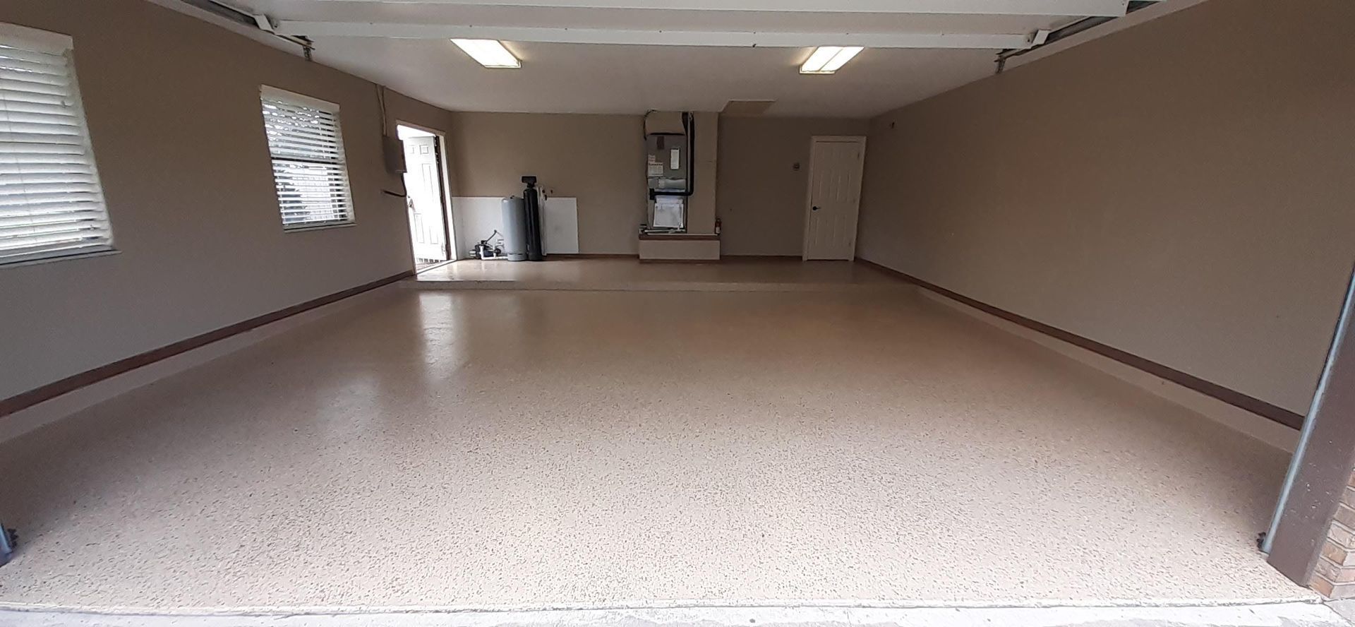 A large empty garage with a concrete floor and walls.