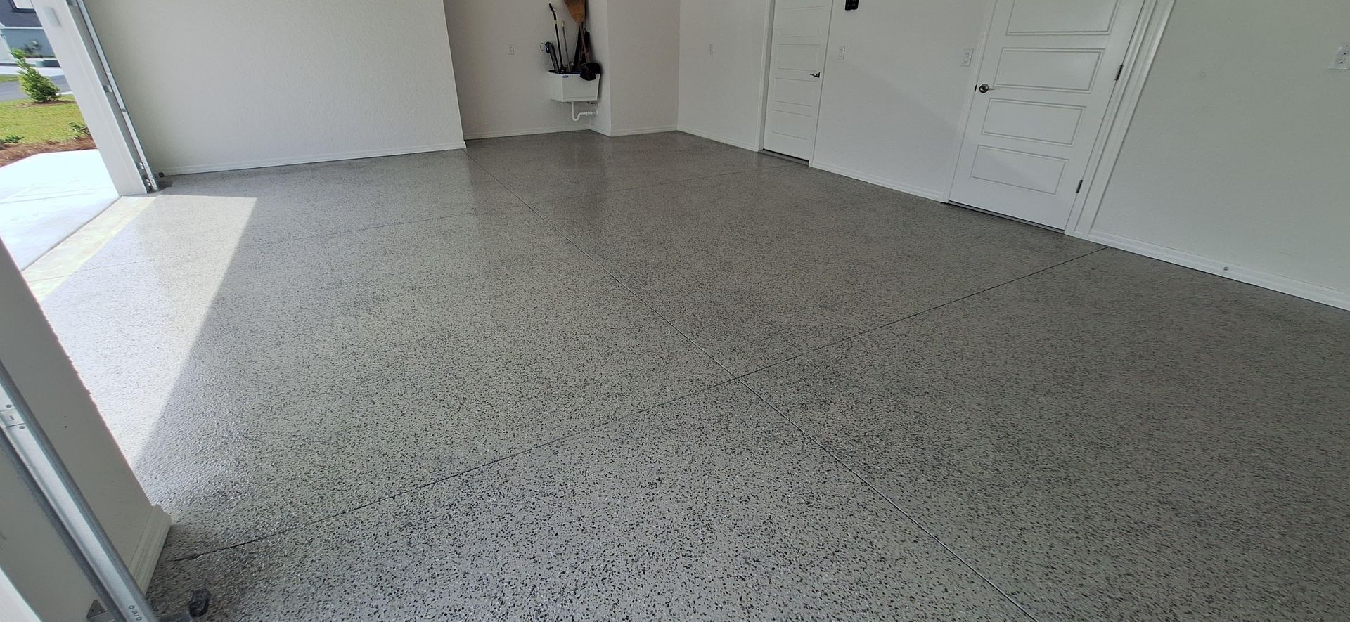 A garage with a concrete floor and white walls.