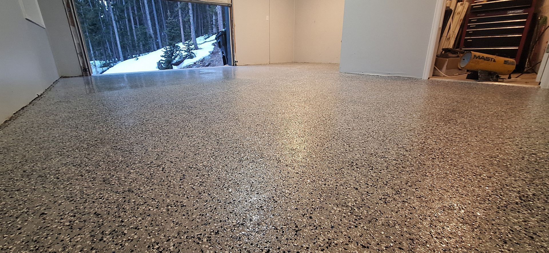 A room with a shiny floor and a window.