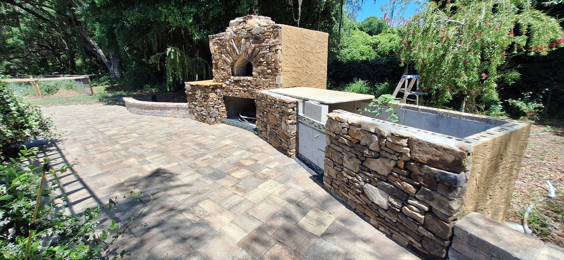 A stone wall with a sink in the middle of it