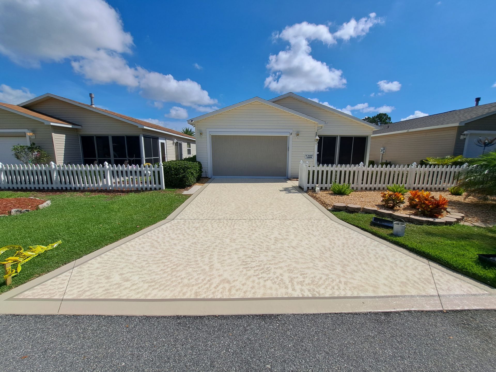 A driveway leading to a mobile home with a canopy over it.
