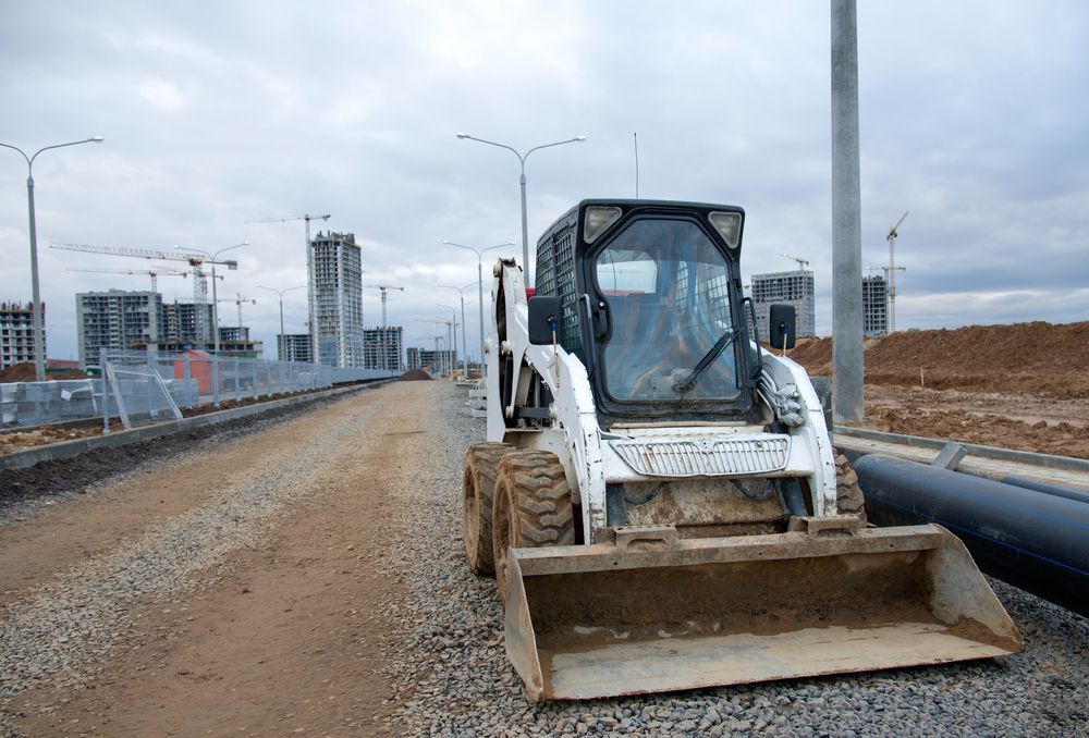 A Bulldozer is Driving Down a Dirt Road — Ensbey Earthmoving in Glenview, QLD