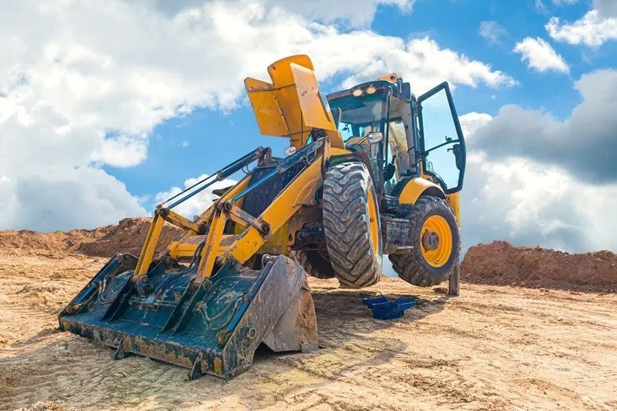 A Yellow Bulldozer is Sitting on Top of a Dirt Field — Ensbey Earthmoving in Glenview, QLD
