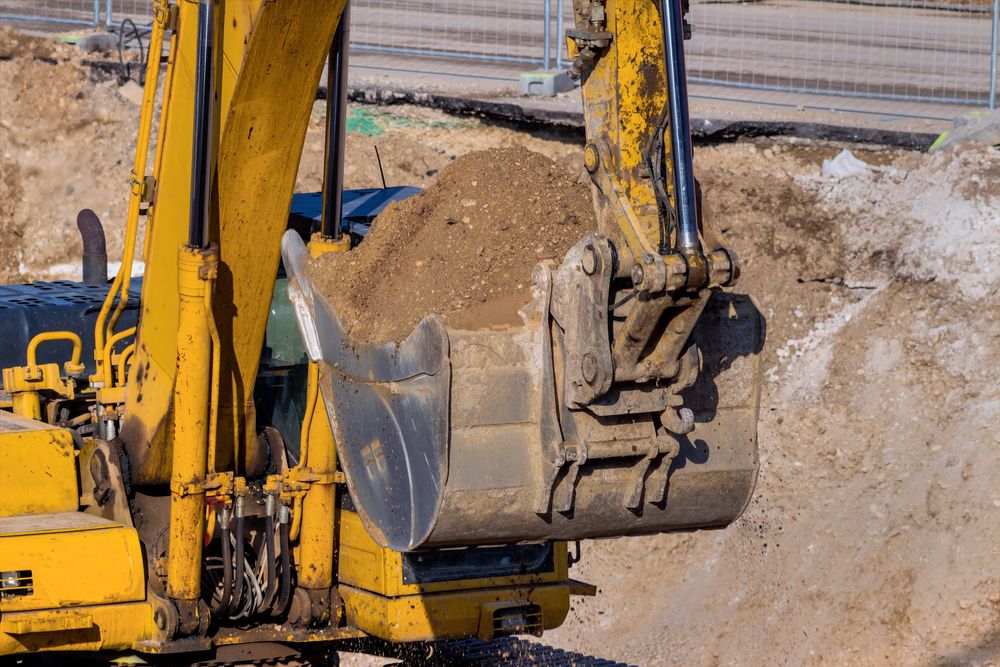 A Excavator is Loading Dirt in a Construction Site — Ensbey Earthmoving in Caloundra, QLD