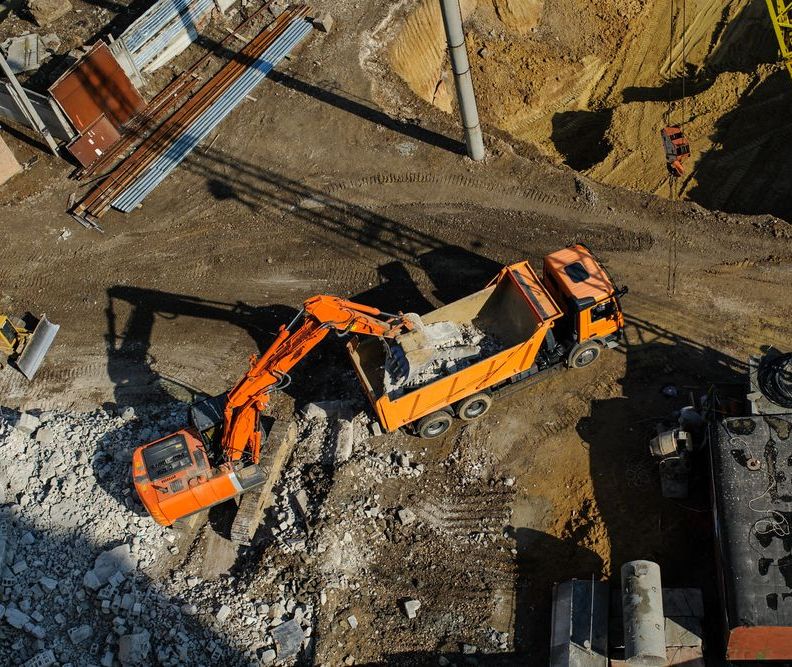 An Aerial View of a Construction Site With a Dump Truck and an Excavator — Ensbey Earthmoving in Glenview, QLD