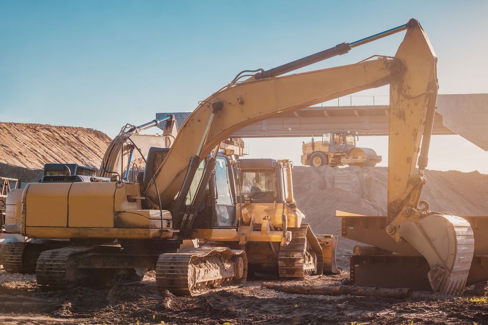 A Large Yellow Excavator is Working on a Construction Site — Ensbey Earthmoving in Glenview, QLD