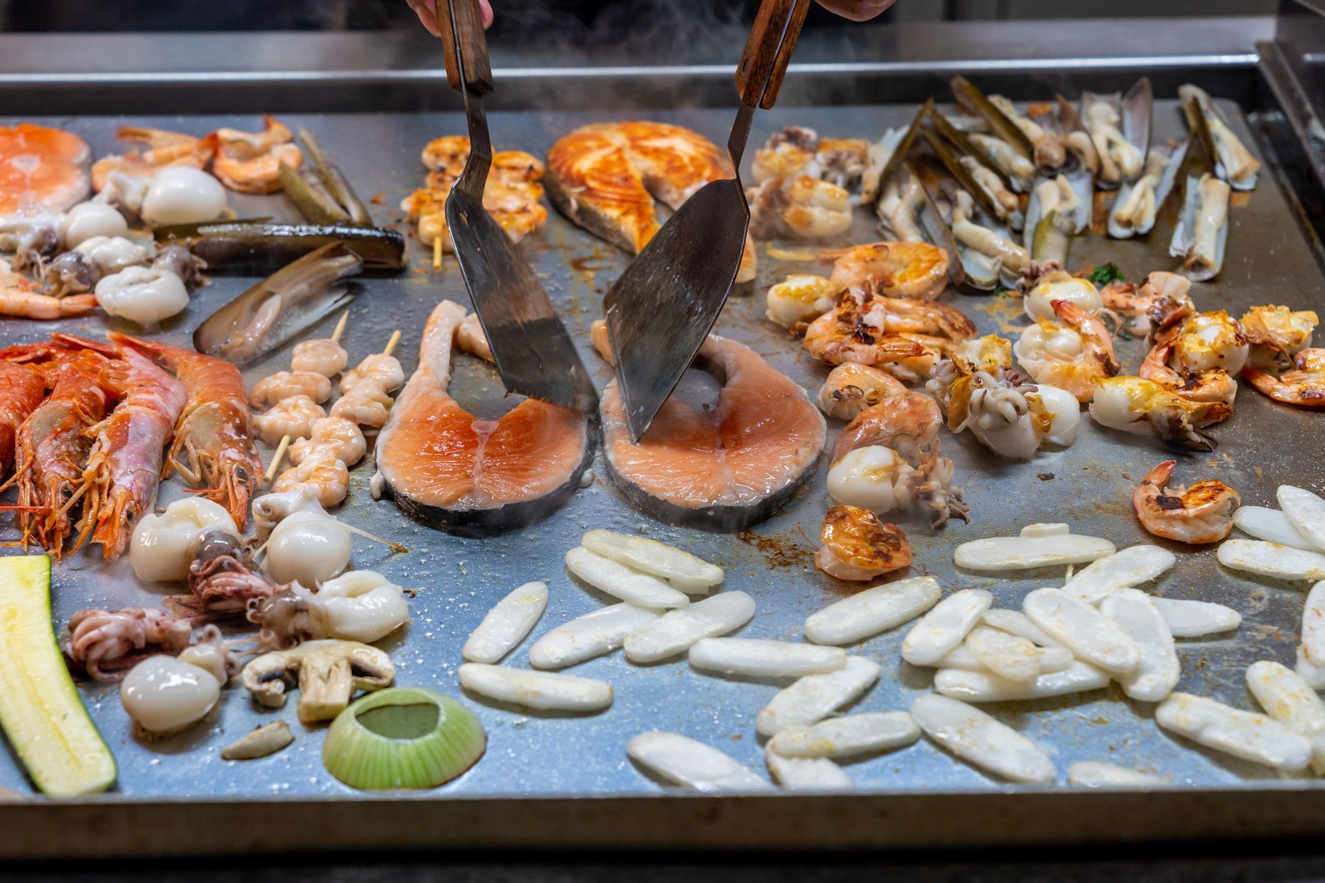 Chef cooking fresh seafood on a grill
