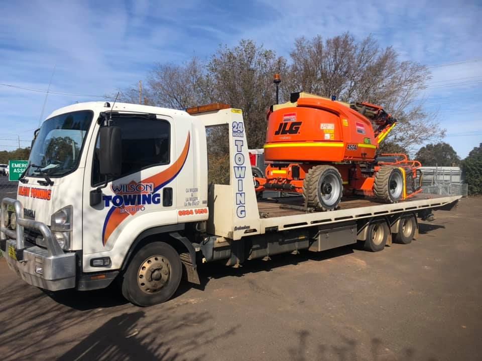 The tow truck on the platform transports the new tractor — Tow in Dubbo, NSW