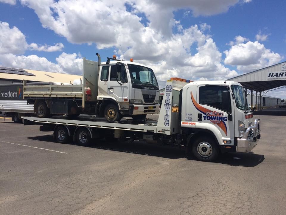 Tow truck with broken car on country road — Tow in Dubbo, NSW