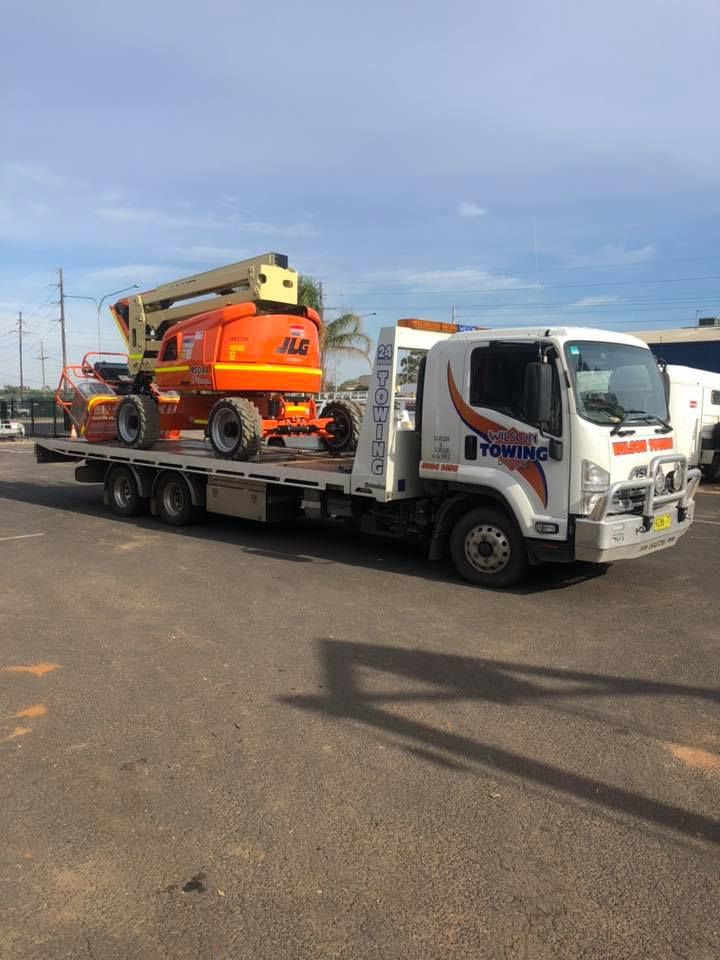 Truck with a long trailer platform for transporting heavy machinery — Tow in Cobar, NSW