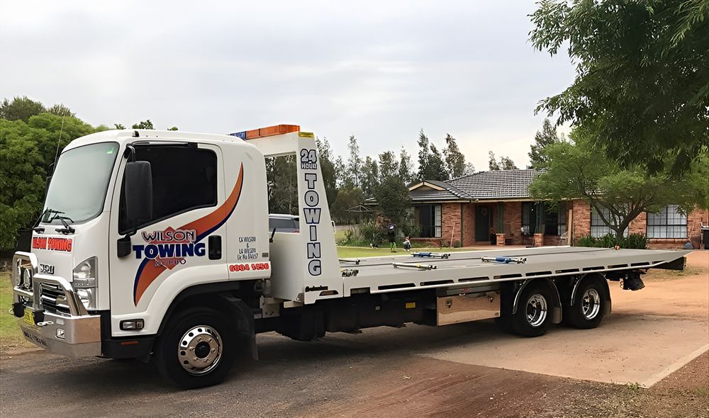 White Tow Truck Parked on a Driveway in Front of a House — Tow in Dubbo, NSW